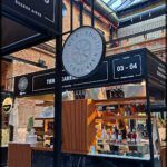 arafed area with a clock and a sign for a restaurant