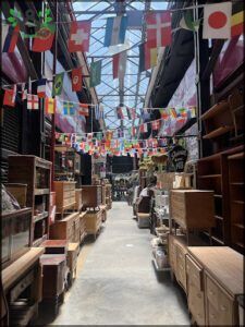 arafed area with a lot of furniture and flags hanging from the ceiling