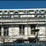 arafed scaffolding on a building with a sign that says beacon on the way