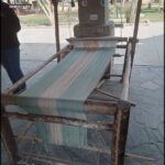 arafed weaving machine on a stone patio with a person standing next to it