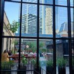 araffe view of a city from a restaurant with a glass roof