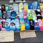 araffes are on the ground with a sign and a bunch of socks