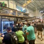 people are standing in line at a food truck that sells drinks