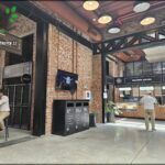 people sitting at tables in a restaurant with a television on the wall