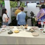 people standing around a table with plates of food on it