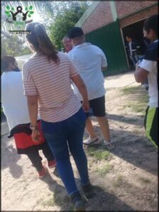 several people are walking in a line in a yard