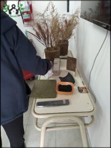 someone is cleaning a table with a brush and a tv