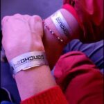 someone is holding a wrist with a wristband that says,