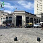 there are many cars parked in front of a building on a street