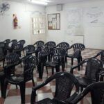 there are many chairs in a room with checkered floor