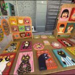 there are many different colored paintings on a table