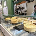 there are many different types of pies on display in a bakery