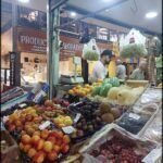 there are many fruits and vegetables on display at a market