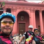 there are many people riding bikes in front of a building