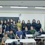 there are many people standing in a classroom together