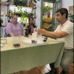 there are people sitting at a table with wine glasses on it