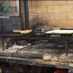 there are some food cooking on a grill in a kitchen