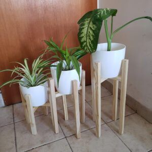 there are three planters that are on the floor near a door