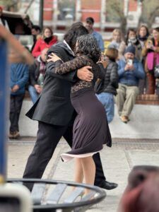 there are two people that are hugging each other on the street