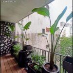 there are two planters on the balcony of a building