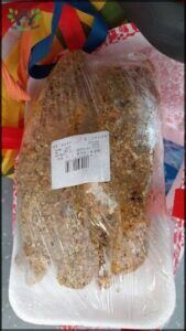 there is a bag of bread sitting on a table with a ribbon