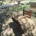 there is a bench and a bench made out of hay
