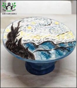 there is a cake with a painting on it on a table