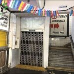 there is a doorway leading to a building with a bunch of signs