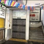 there is a doorway leading to a building with a bunch of signs