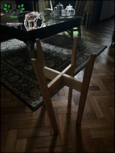there is a glass table with a vase on it in a living room