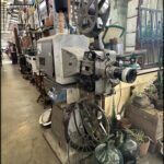 there is a machine that is sitting in a room with many pots