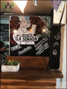 there is a man standing at a counter in a restaurant