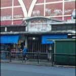 there is a man walking down the street in front of a building