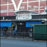 there is a man walking down the street in front of a building