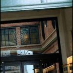 there is a man walking down the street with a cell phone