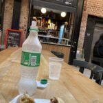 there is a plate of food on a table with a bottle of water