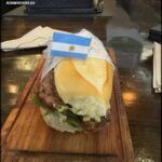 there is a sandwich with a flag on it on a cutting board