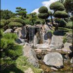 there is a small waterfall in the middle of a garden
