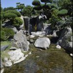 there is a small waterfall in the middle of a pond