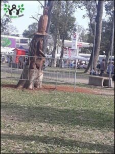 there is a statue of a man standing next to a tree