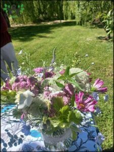 there is a vase of flowers on a table outside