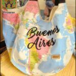 there is a woman holding a bag with a map on it