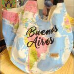 there is a woman holding a bag with a map on it