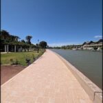 A brick walkway overlooking a body of water.