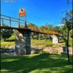 A bridge over a river with a sign on it.