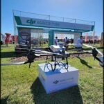 a close up of a small drone on a display in a field