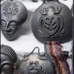 A collection of unique and artistic masks are displayed on a table.