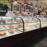 A display case filled with a variety of pastries and desserts.