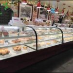 A display case filled with a variety of pastries and desserts.