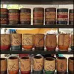 A display of wooden cups with various designs and colors.